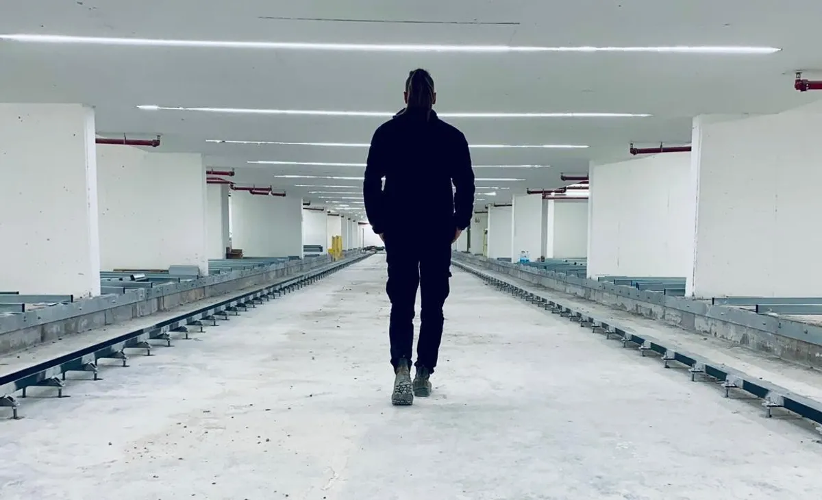 Igor Gabriielian walking through an automated parking level under construction
